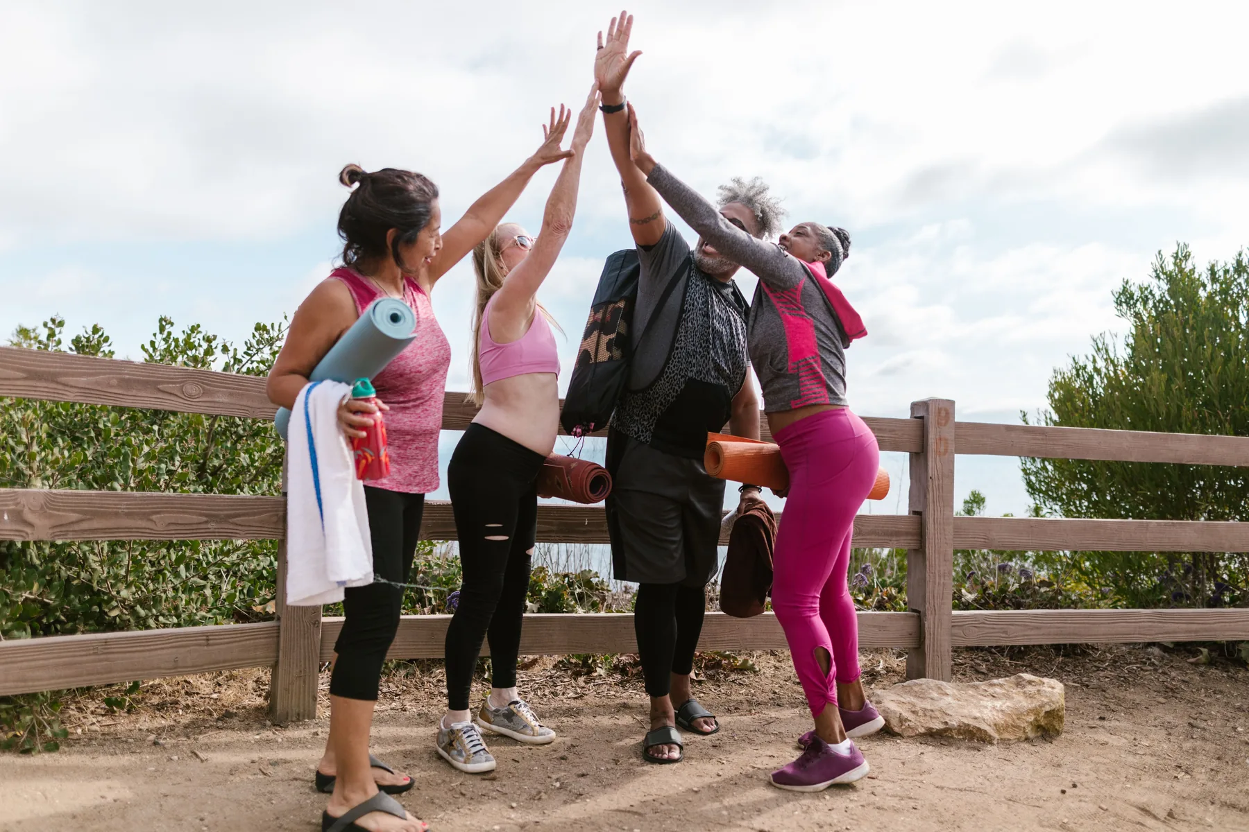 Friends celebrating after an outdoor wellness session